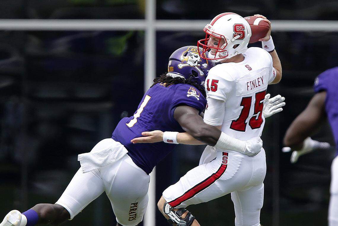 East Carolina linebacker Dayon Pratt (1) sacks N.C. State quarterback Ryan Finley (15) during the Pirates’ 33-30 victory in in Greenville in 2016.