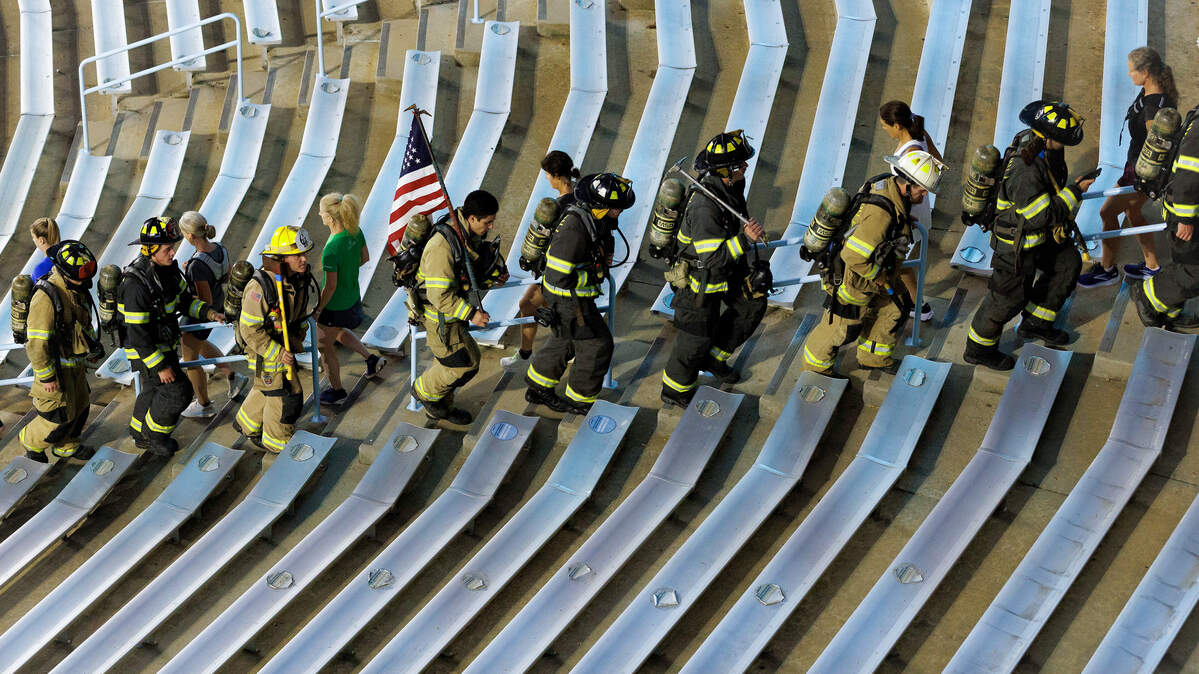 Participants climb the stairs of Kenan Memorial Stadium during an event in Chapel Hill, N.C. on Thursday, Sept. 11, 2025, to honor those who lost their lives during attacks of Sept. 11, 2001. 