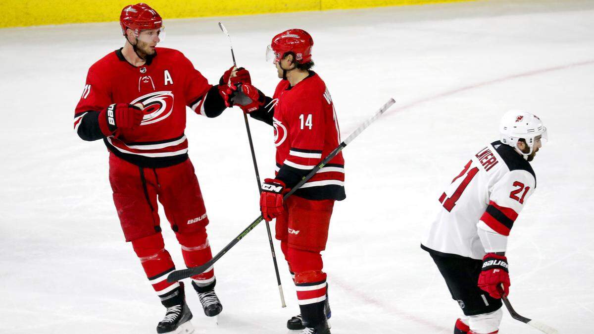 Jordan Staal, left, and Justin Williams celebrate Williams' empty-net goal that gave the Carolina Hurricanes a 3-1 win over the New Jersey Devils on Friday.