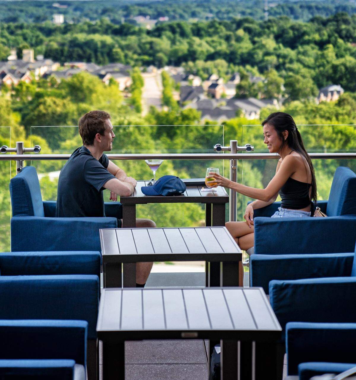 Andrew Herr and Grace Paik enjoy drinks at 10th and Terrace rooftop bar in downtown Raleigh, N.C. on Tuesday, June 21, 2022.
