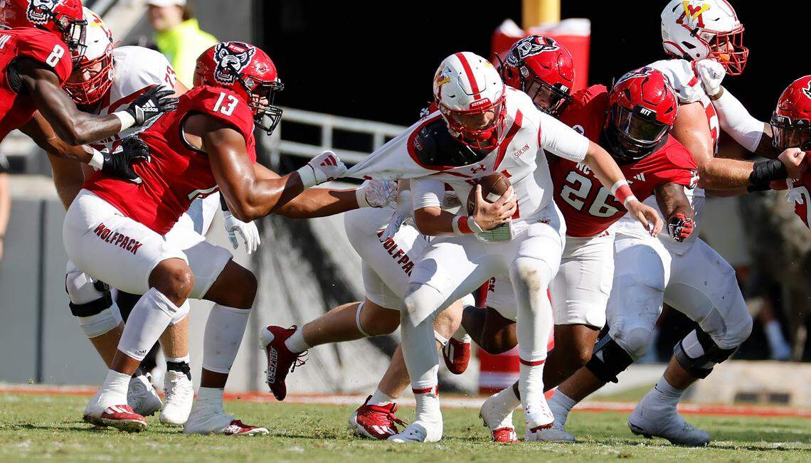 N.C. State defensive end Travali Price (13) and the defense work to sack Virginia Military Institute quarterback Collin Shannon (1) during the second half of the Wolfpack’s 45-7 victory over VMI at Carter-Finley Stadium in Raleigh, N.C., Saturday, Sept. 16, 2023.