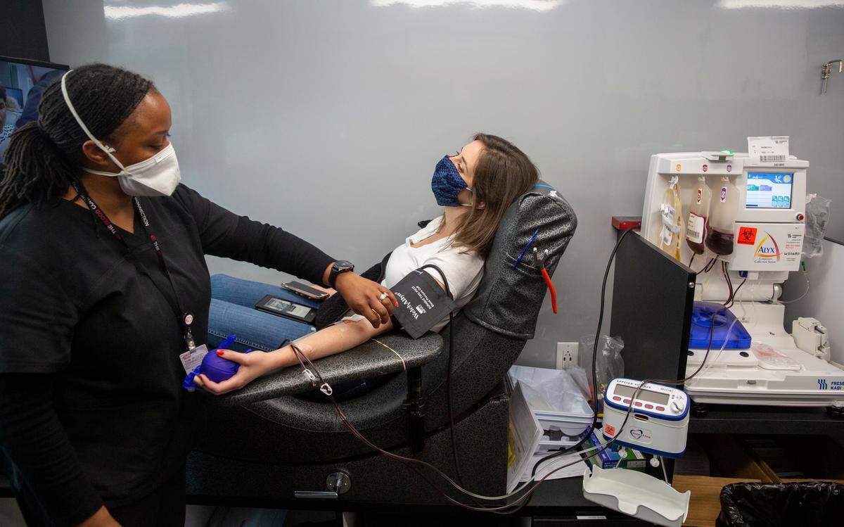 Camille Botts has plasma drawn by Toccara Anderson in one of The Blood Connection’s mobile units. Botts had COVID-19 and developed antibodies to the virus. So she enrolled as a participants/plasma donors in the MESSI study. Shawn Rocco/Duke Health shawn.rocco@duke.edu office: 919-668-0994 cell: 919-812-8291