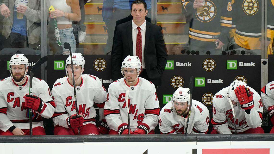 Carolina Hurricanes head coach Rod Brind’Amourin, top, and members of the team watch as the Hurricanes trail the Boston Bruins in the third period of Game 4 of an NHL hockey Stanley Cup first-round playoff series, Sunday, May 8, 2022, in Boston. (AP Photo/Steven Senne)