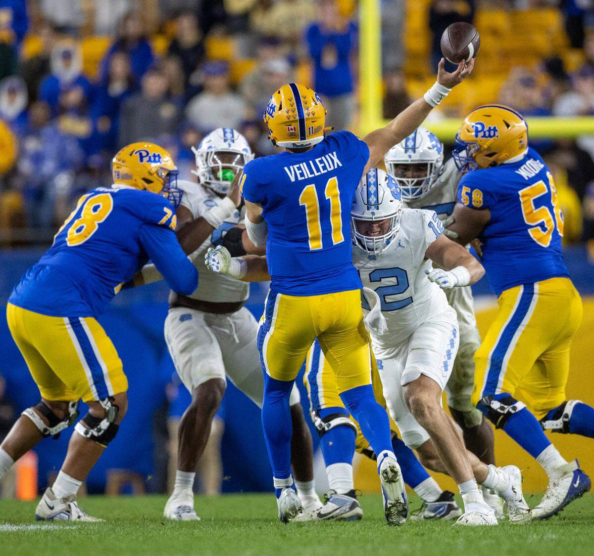 North Carolina’s Beau Atkinson (12) pressures Pitt quarterback Christian Veilleux (11) who was intercepted on this play by Alijah Huzzie in the third quarter on Saturday, September 23, 2023 at Acrisure Stadium in Pittsburgh, Pa.