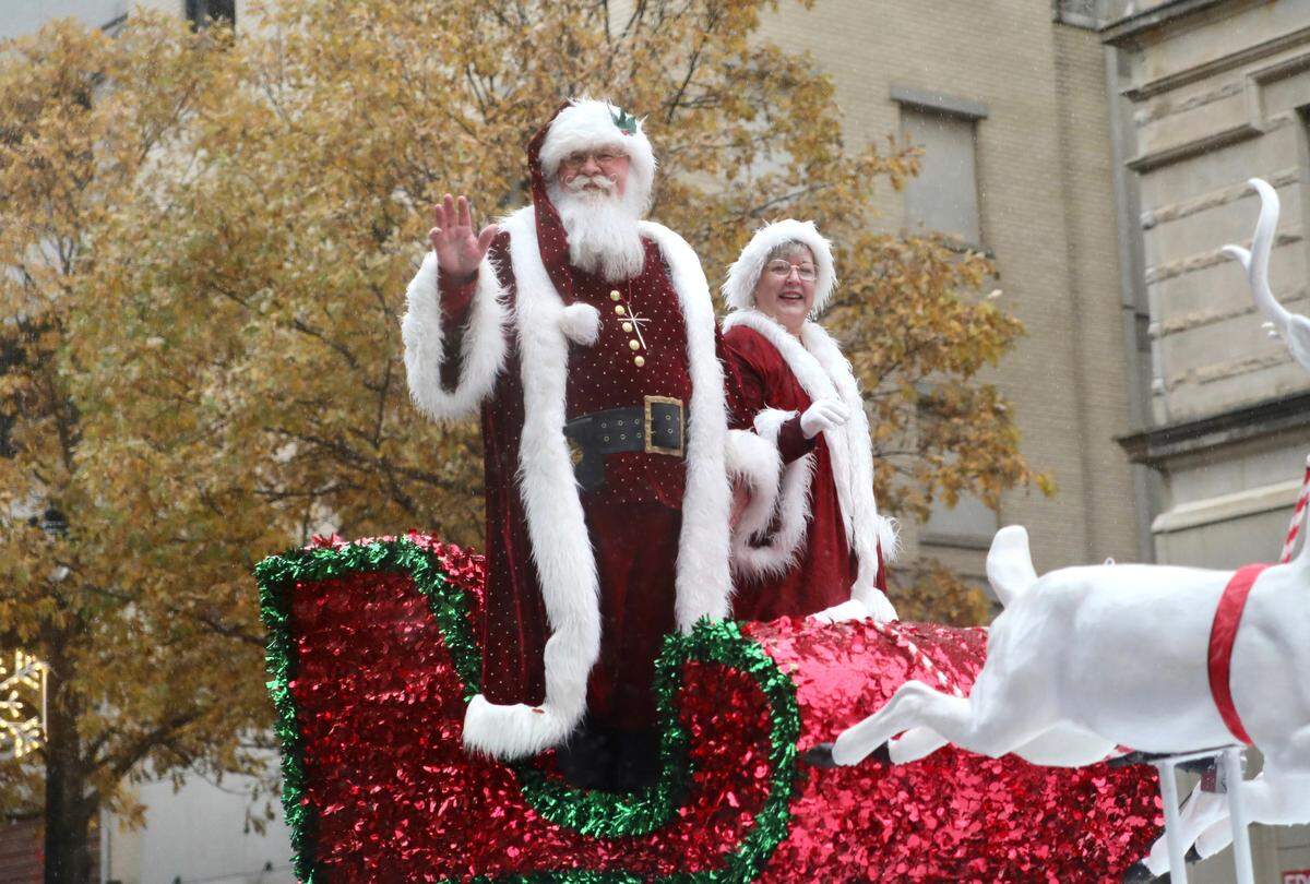 Santa Claus and Mrs. Claus wave to the crowd during the Raleigh Christmas Parade in Raleigh, N.C. on November 23, 2019.