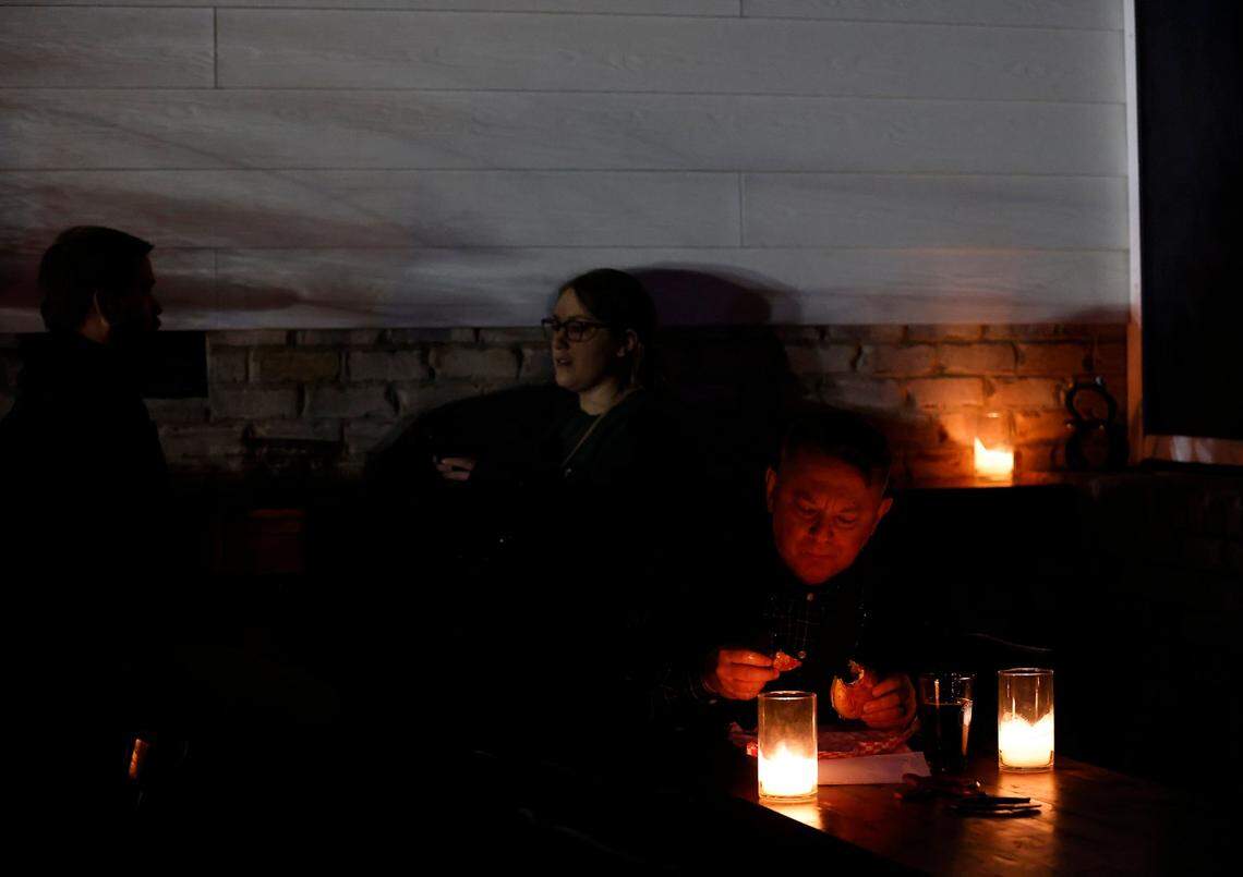 Patrons dine by candelight at Red’s Corner during the Moore County power outage on Monday, Dec. 5, 2022, in Southern Pines, N.C.