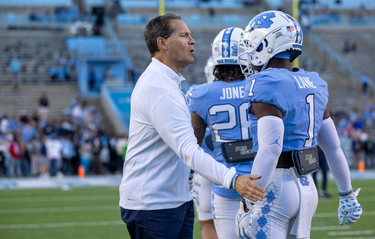 North Carolina assistant head coach for defense Gene Chizik talks with Antavious Lane (1) prior to the Tar Heels’ game against Virginia on Saturday, October 21, 2023 at Kenan Stadium in Chapel Hill, N.C.
