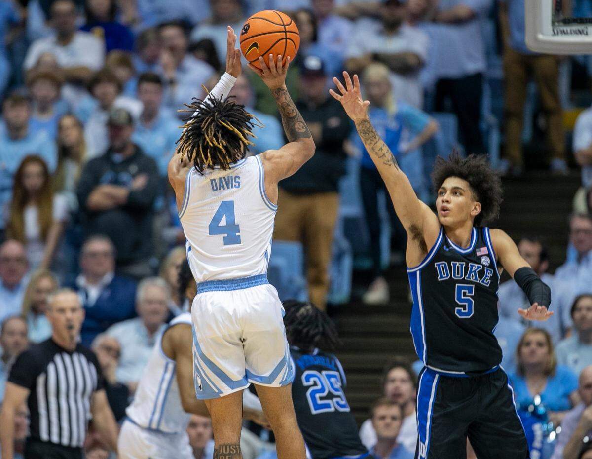 North Carolina’s R.J. Davis (4) puts up a shot against Duke’s Tyrese Proctor (5) in the first half on Saturday, March 4, 2023 at the Smith Center in Chapel Hill, N.C.