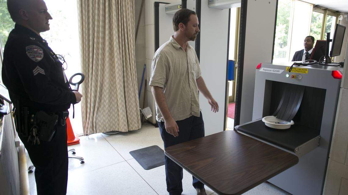 State employee Vann Evans picks up his items after having them scanned before entering the North Carolina State Legislative Building on Jones Street on Monday, May 14, 2018 in Raleigh, N.C. Visitors to the building can only enter through the north or south entrances and must pass through security screening with two metal detectors and one scanner at each entrance.