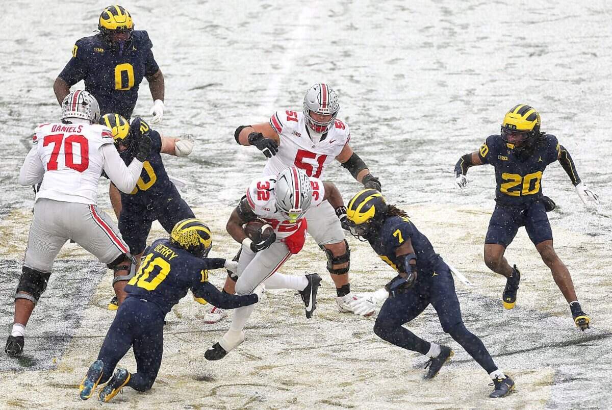 Isaiah West (32) of the Ohio State Buckeyes carries the ball against the Michigan Wolverines at Michigan Stadium on Nov. 29, 2025, in Ann Arbor, Michigan.