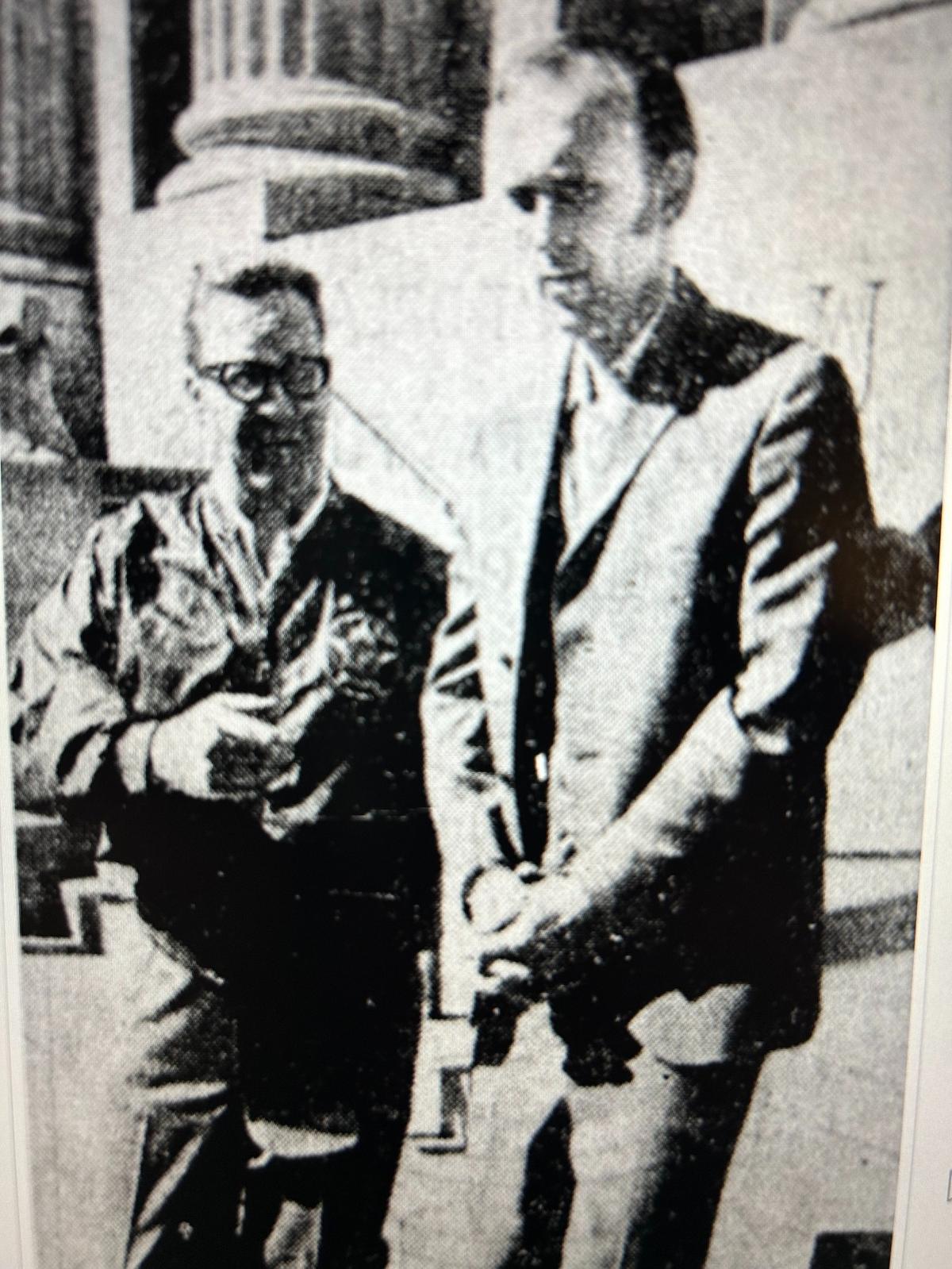 Richard Floyd Jr. led away in handcuffs by a U.S. marshal following his 1972 arrest for parachute hijacking.