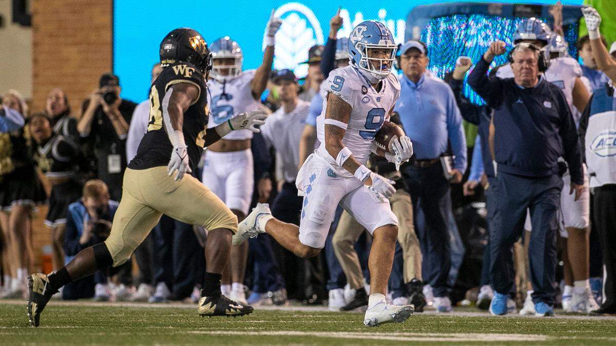 North Carolina’s Cam’Ron Kelly (9) returns an interception of a pass by Wake Forest quarterback Sam Hartman 23-yards in the fourth quarter to set up the game winning field goal on Saturday, November 12, 2022 at Truist Field in Winston-Salem, N.C.