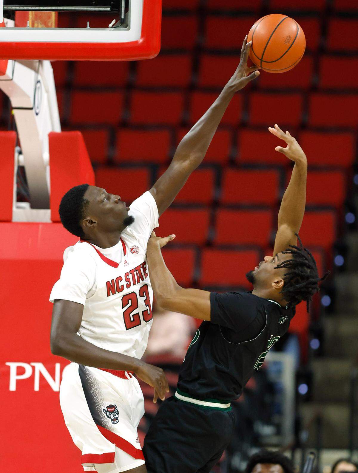 N.C. State’s Mohamed Diarra (23) blocks the shot by Mount Olive’s Brent Randleman (12) during the first half of N.C. State’s exhibition game against Mount Olive at PNC Arena in Raleigh, N.C., Wednesday, Nov. 1, 2023.