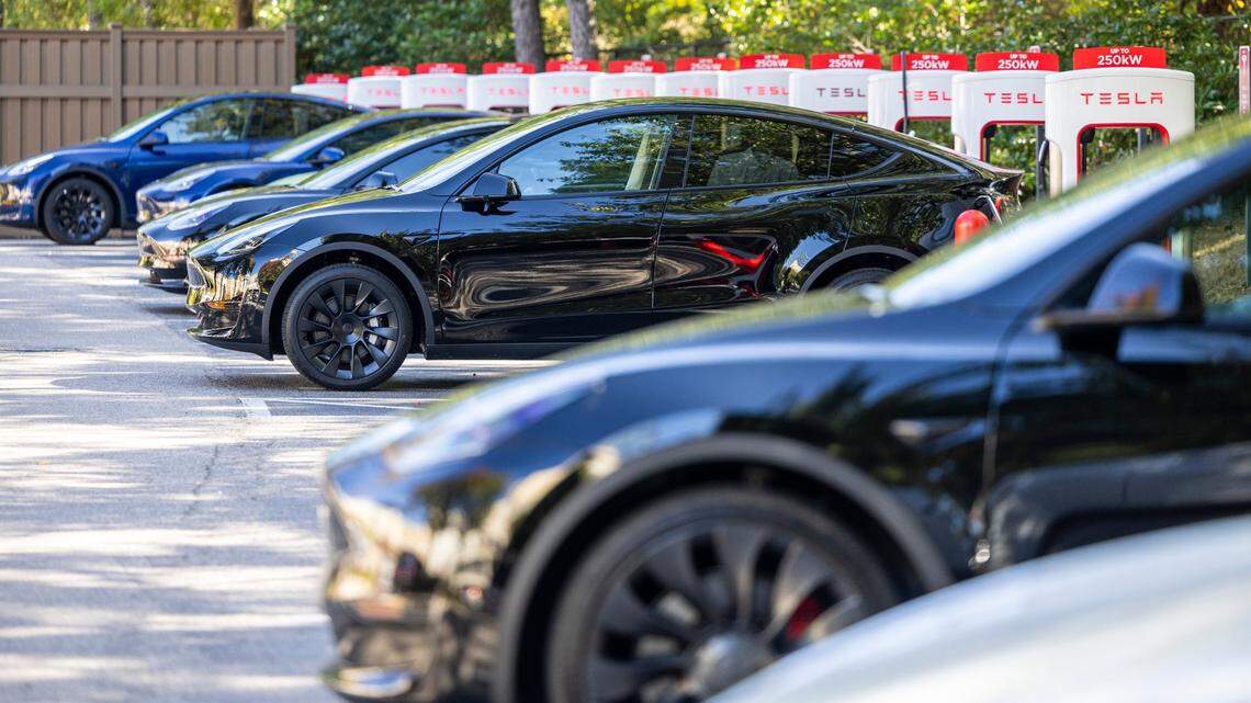 Teslas charge at an electric charging station at North Hills in Raleigh Tuesday, October. 17, 2023. Electric vehicle owners will see an increase in annual registration fees.