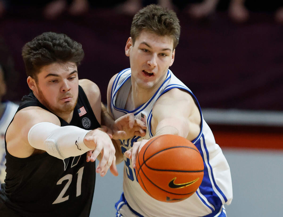 Duke’s Kyle Filipowski (30) and Virginia Tech’s Grant Basile (21) go after the ball during the first half of Duke’s game against Virginia Tech at Cassell Coliseum in Blacksburg, VA., Monday, Jan. 23, 2023.