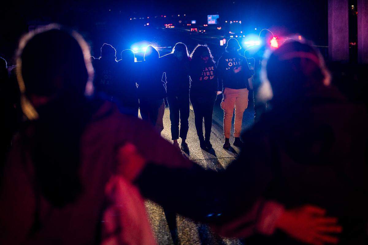 Protesters block the northbound lanes of the Durham Freeway at the South Magnum Street bridge for hours Thursday evening, Nov. 2, 2023 while demanding a ceasefire in the Israel-Gaza War as police warned of arrests.