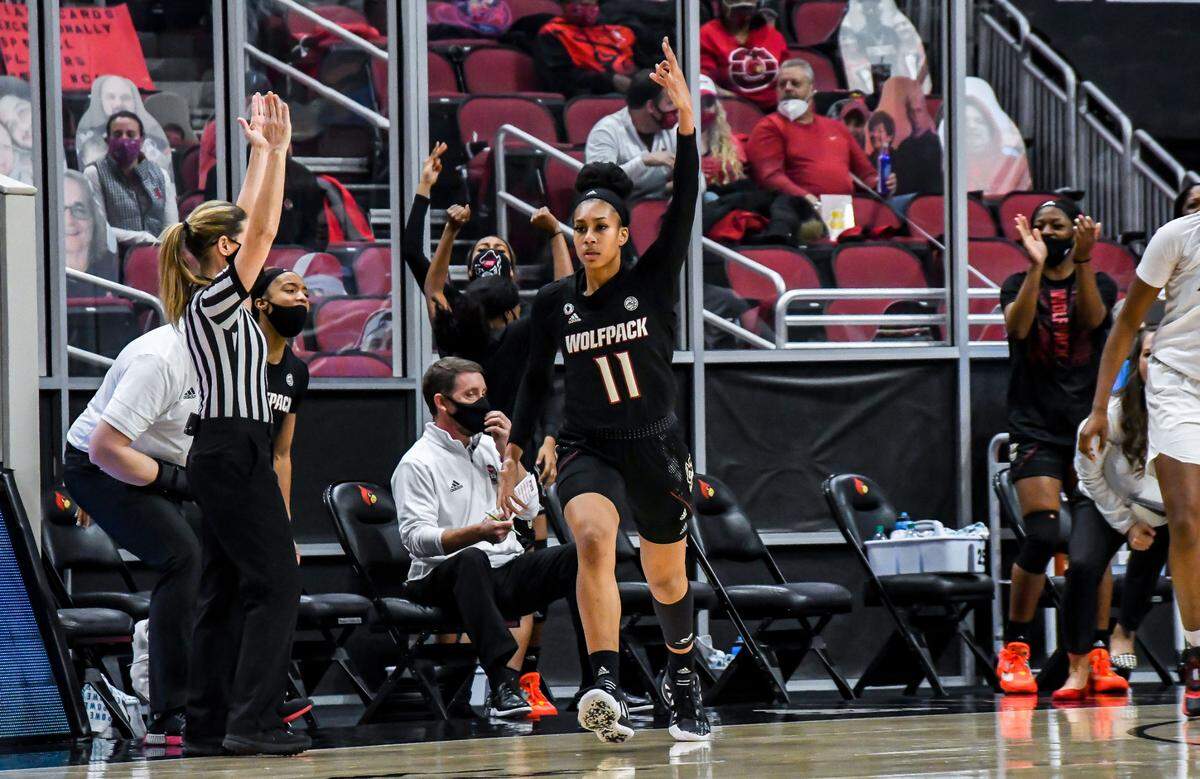 N.C. State’s Jakia Brown-Turner (11) celebrates making a three-pointer during the Wolfpack’s game against Louisville at KFC Yum! Center in Louisville, Ky. Monday, February 1, 2021.