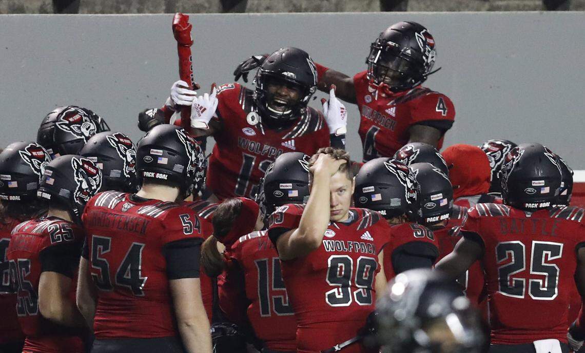 N.C. State defensive back Tyler Baker-Williams (13) celebrates with the turnover bone after intercepting the ball during the first half of N.C. State’s game against Florida State at Carter-Finley Stadium in Raleigh, N.C., Saturday, Nov. 14, 2020.