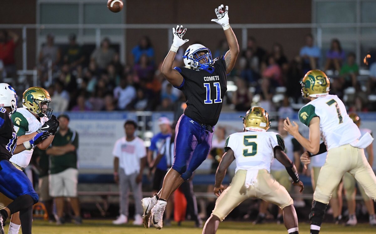 Savion Jackson (11) of Clayton attempts to break a pass thrown by Josh Schindler (7) of South Johnston. The South Johnston Trojans visited the Clayton Comets in a high school football game on October 5, 2018. Clayton won 26-14.