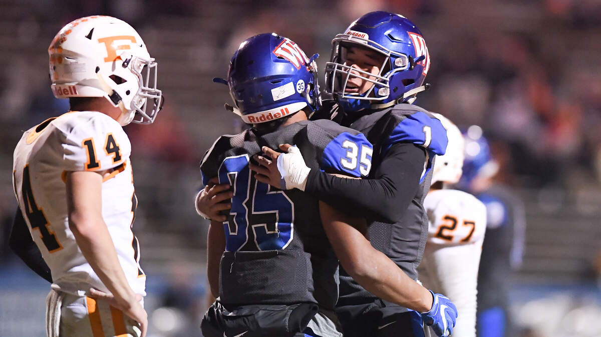Mateo Sudipo (1) of Wake Forest celebrates a touchdown with his teammate Demarcus Jones II (35). The Fuquay-Varina Bengals visited the Wake Forest Cougars in a high school football game on November 23, 2018. Wake Forest won 55-7.