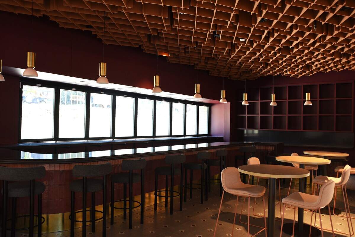 The new food hall at the NC State Fairgrounds features an indoor bar with a walk-up window on a large outdoor patio.