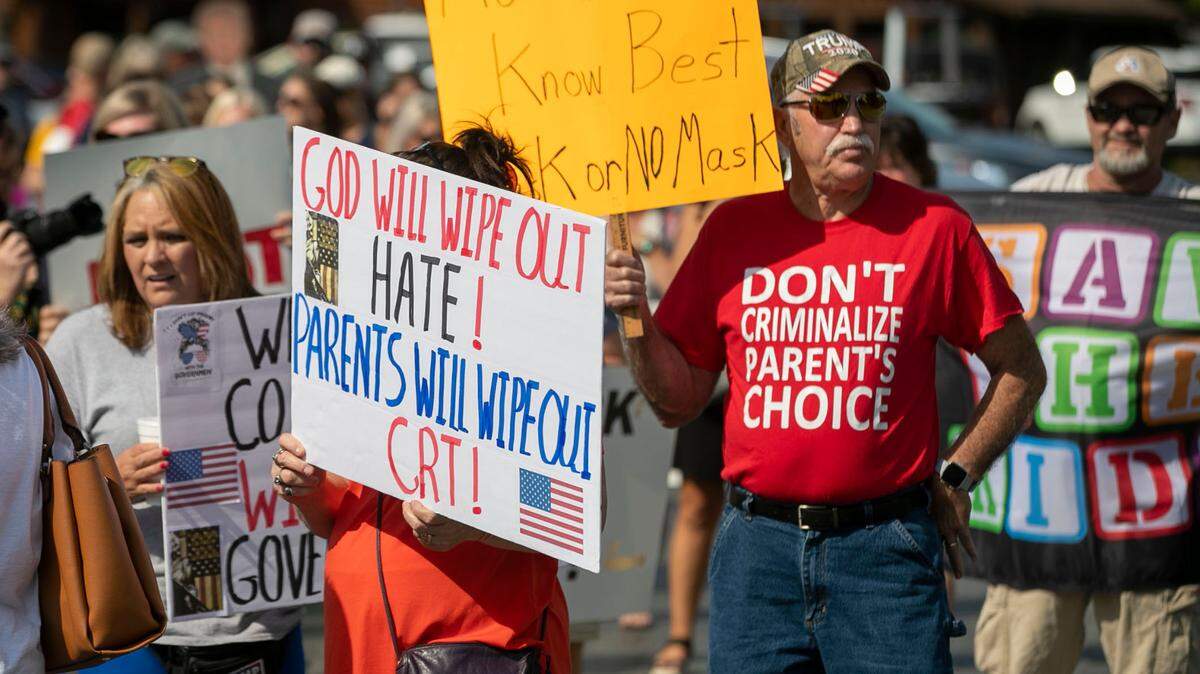 Demonstrators line up to march to the Johnston County School Board meeting to voice their opposition to a mask mandate and the teaching of Critical Race Theory on Tuesday, Sept. 14, 2021 in Smithfield, N.C.