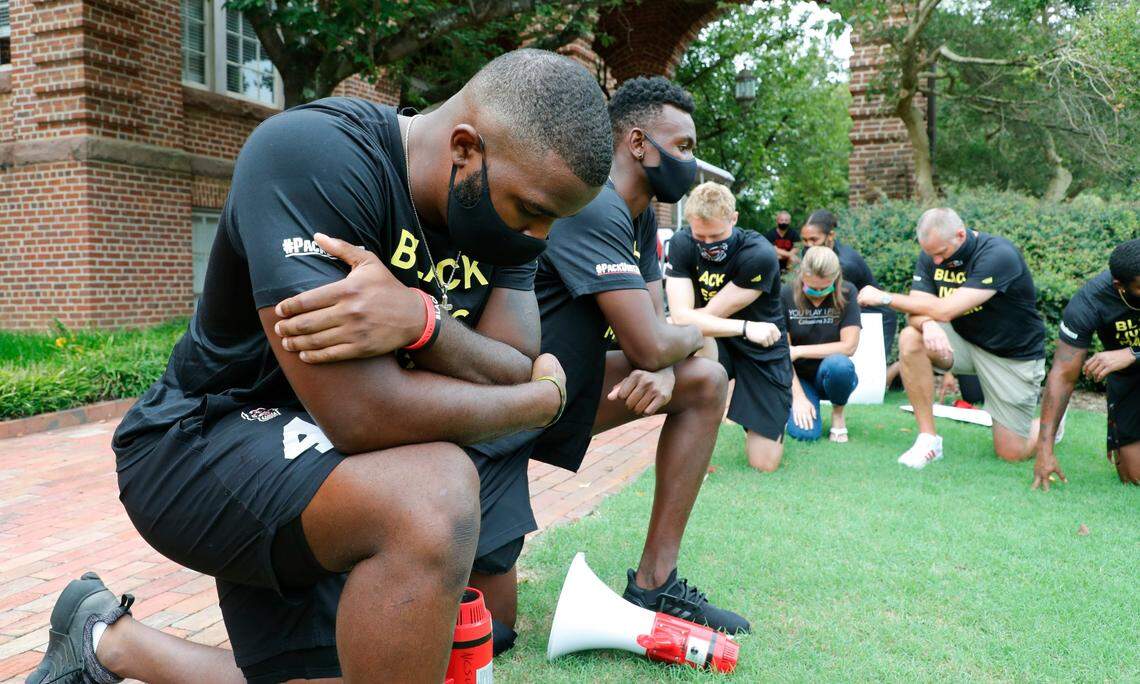 N.C. State’s Isaiah Moore along with other Wolfpack athletes, coaches and staff kneel for 8:46, the time police kneeled on George Floyd, during a #PackUnited peaceful protest against racial and social injustice outside Holladay Hall on the campus of N.C. State Saturday, Sept. 12, 2020.