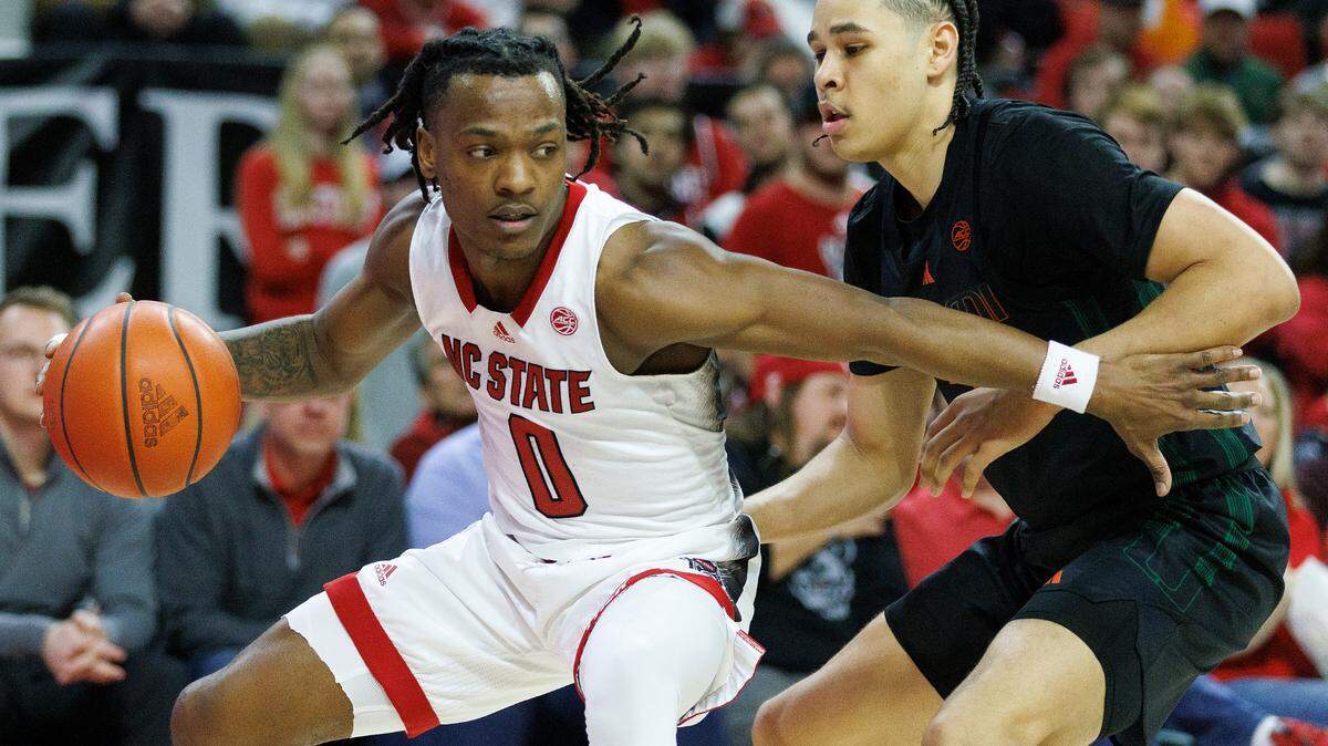 N.C. State’s DJ Horne drives past Miami’s Kyshawn George on Jan. 30 at PNC Arena in Raleigh, N.C. On Saturday, Horne had 27 points in a win over Clemson.