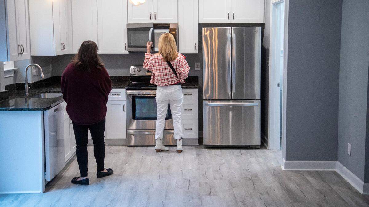 First-time home buyer Carolina Acuipil, left, and Real Estate Broker Colleen Blondell tour a home for sale in Cary on Thursday, April 27, 2023.