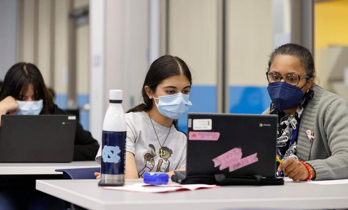 Martina Harper, lead tutor, works with eighth-grader Gurvani Brar at the Emily K Center in Durham, N.C., Thursday, Feb. 24, 2022.