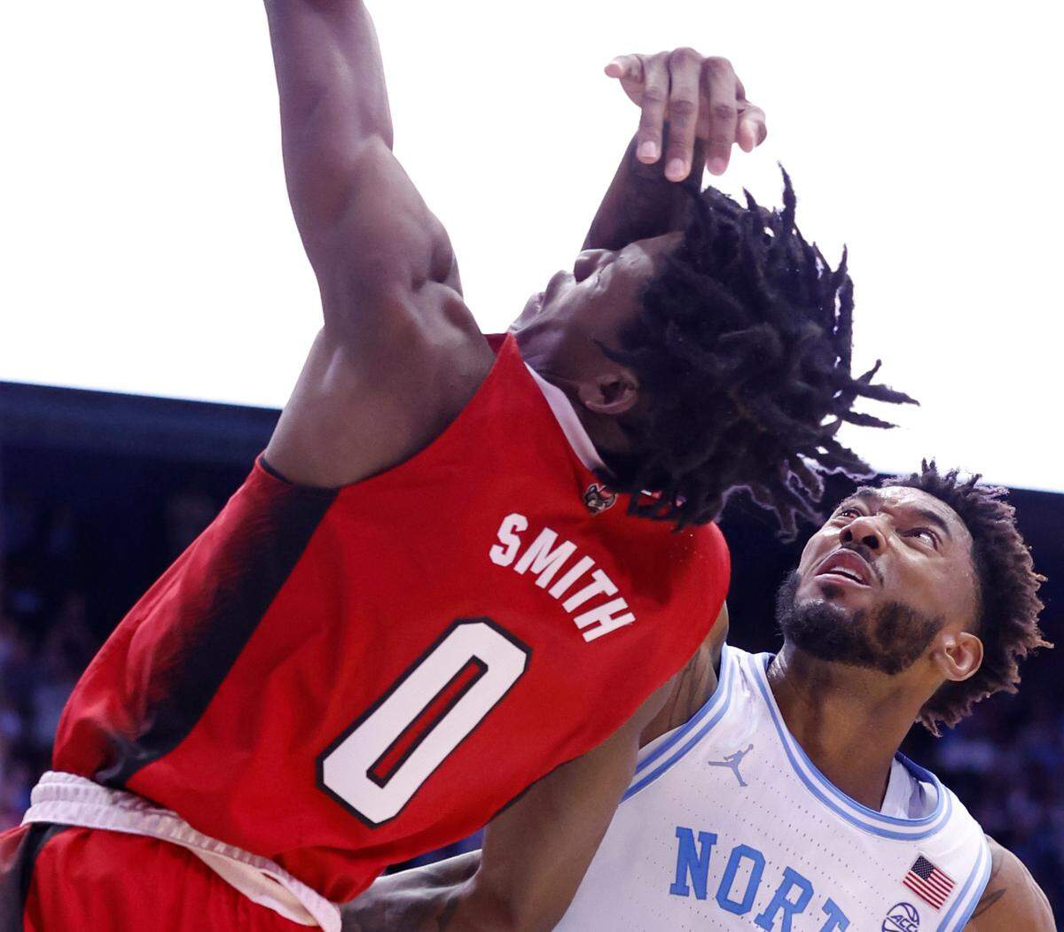 North Carolina’s Leaky Black (1) fouls N.C. State’s Terquavion Smith (0), causing him to fall to the floor and be injured during the second half of UNC’s 80-69 victory over N.C. State at the Smith Center in Chapel Hill, N.C., Saturday, Jan. 21, 2023.