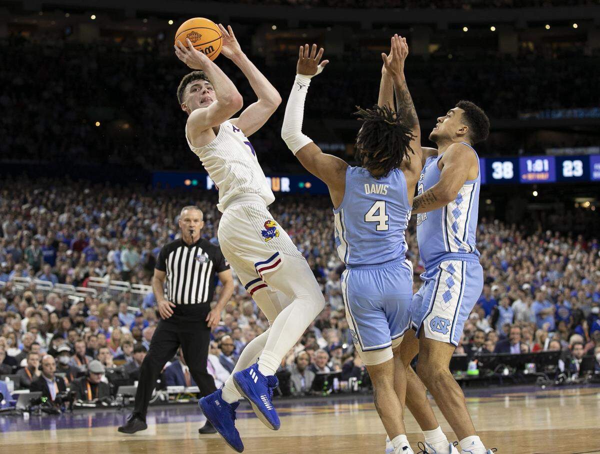 North Carolinas R.J. Davis (4) and Justin McKoy (22) defend Kansas Christian Braun (2) during the first half of the NCAA Championship game on Monday, April 4, 2022 at Caesars Superdome in New Orleans, La