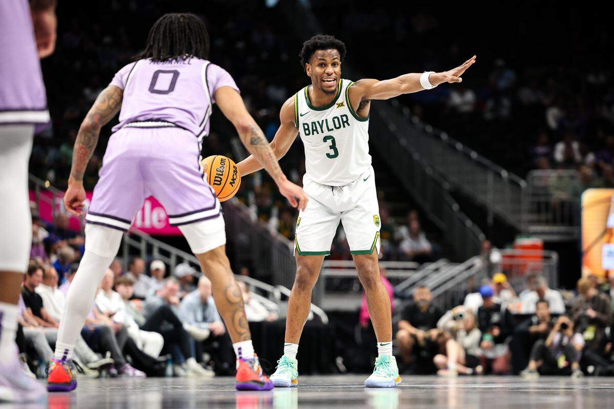 Mar 12, 2025; Kansas City, MO, USA; Baylor Bears guard Jeremy Roach (3) sets the play around Kansas State Wildcats guard Dug McDaniel (0) during the first half at T-Mobile Center.