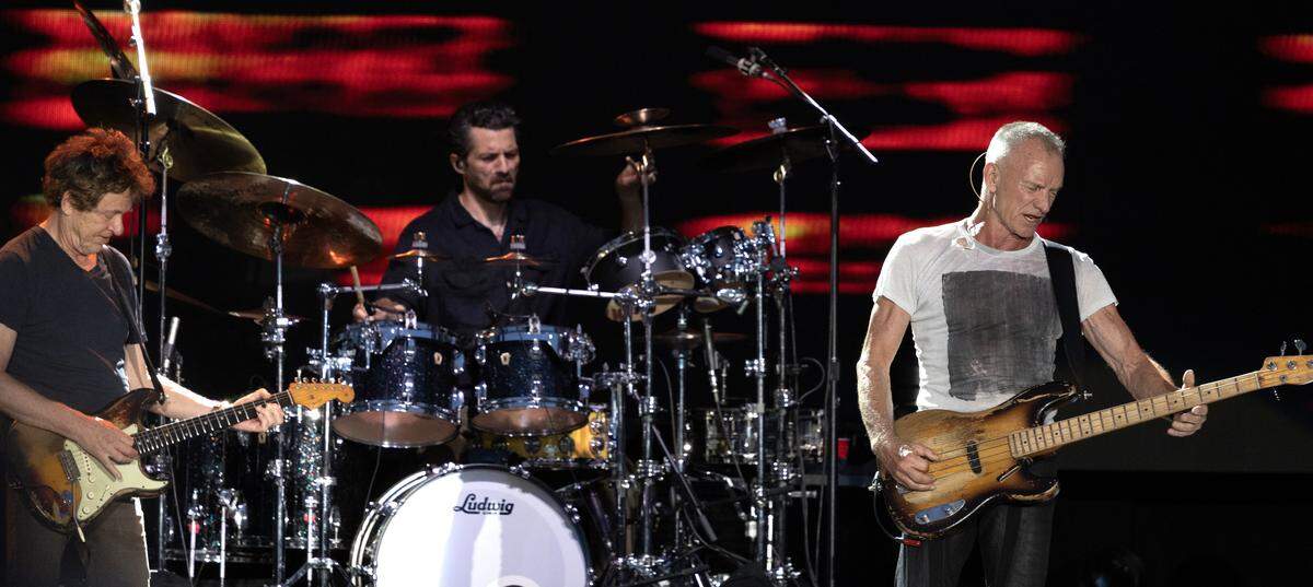 Guitarist Dominic Miller and drummer Chris Maas accompany Sting on “I Wrote Your Name (Upon My Heart)” in Raleigh.