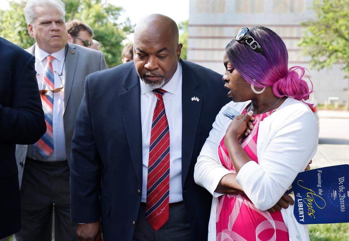 Republican Lt. Gov. Mark Robinson talks with Tia Bess, director of national engagement for Moms for Liberty, after Lt. Gov. Robinson spoke at the Moms for Liberty rally outside the Legislative Building in Raleigh, N.C., Wednesday, June 12, 2024.