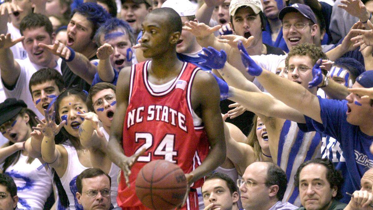 N.C. State’s Julius Hodge is hounded by the Cameron Crazies as he gets ready to make a throw-in during their game against Duke in February 2003.