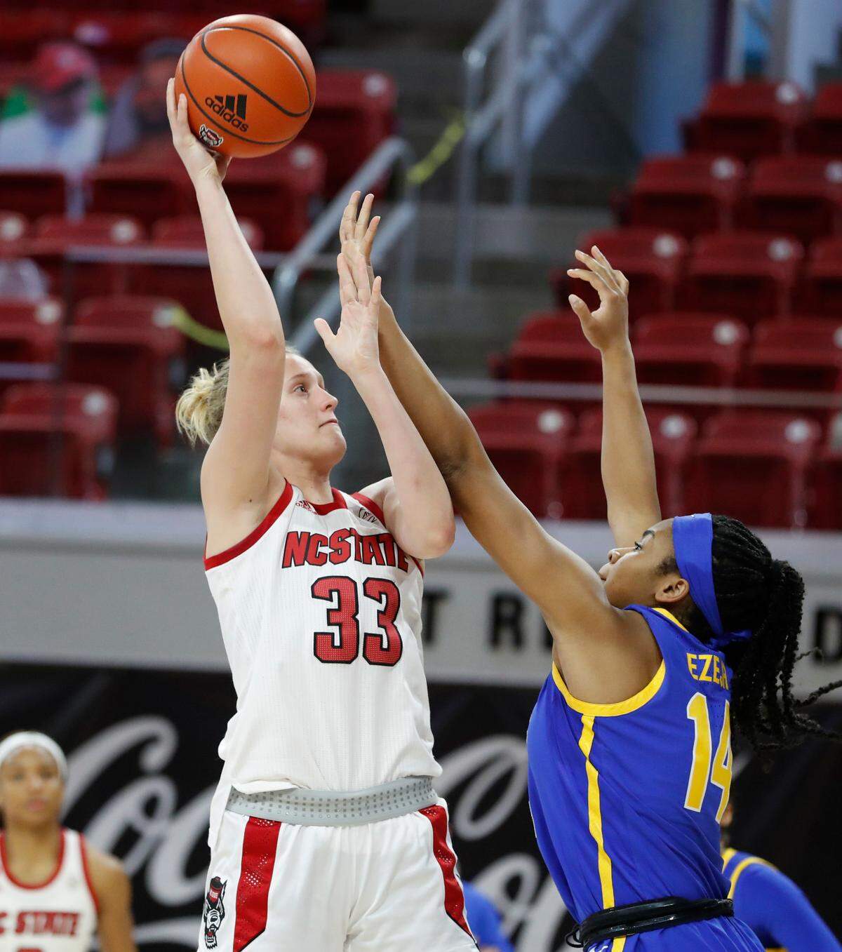 N.C. State’s Elissa Cunane (33) shoots as Pittsburgh’s Cynthia Ezeja (14) defends during the first half of N.C. State’s game against Pittsburgh at Reynolds Coliseum in Raleigh, N.C., Thursday, February 25, 2021.