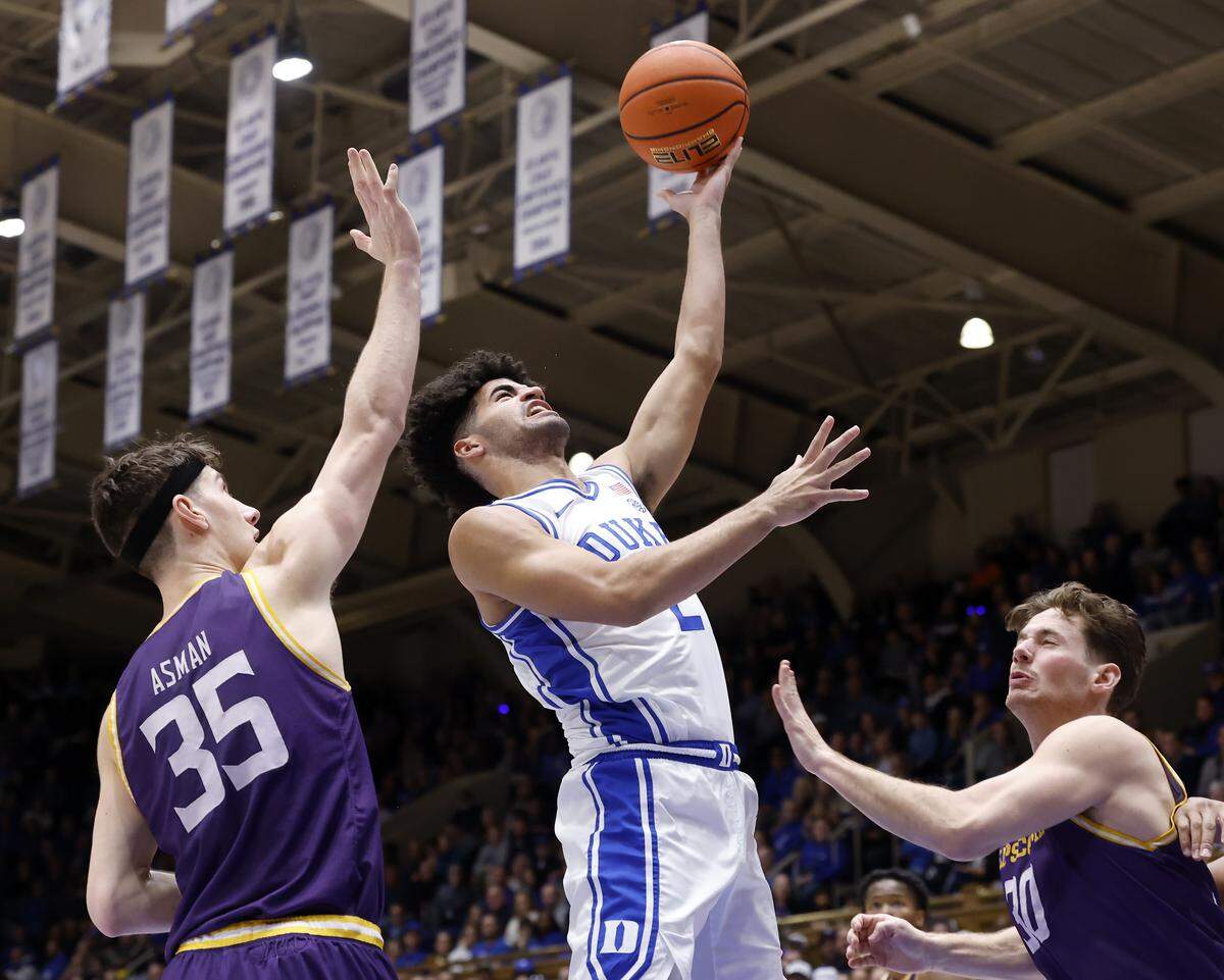 Duke’s Cayden Boozer drives to the basket past Lipscomb's Grant Asman and Lipscomb's Ross Candelino during the first half of the Blue Devils’ game on Tuesday, Dec. 16, 2025, at Cameron Indoor Stadium in Durham, N.C.