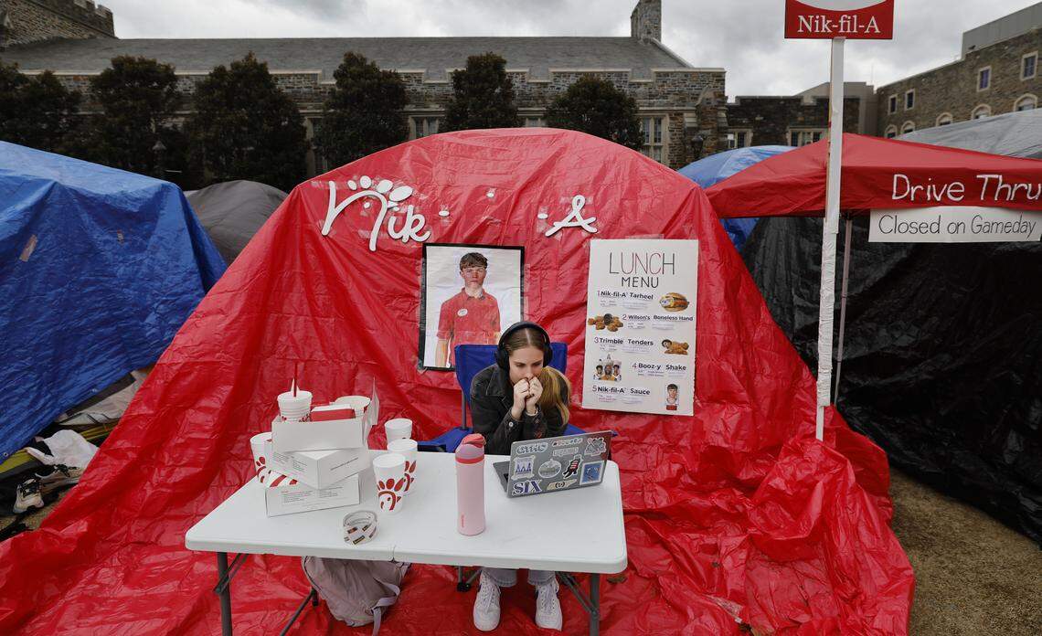 Duke senior Latham Hall works outside a tent at Krzyzewskiville at Duke University in Durham, N.C., Wednesday, Feb. 18, 2026. It is the 40th anniversary of the annual tent city for tickets for the Blue Devils’ game against North Carolina.