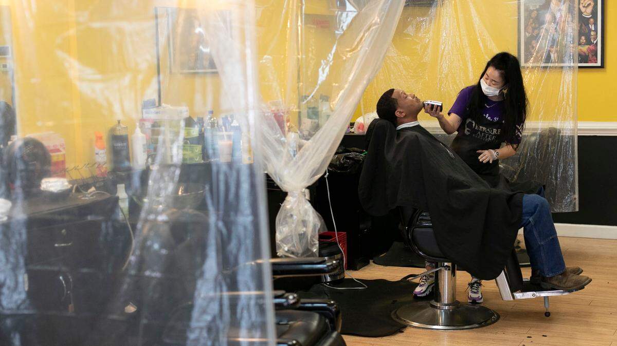 ‘True the Barber’ works with customer Bryson Thaxton at Before & After Barbershop on Poole Road in Raleigh on Thursday, March 25, 2021.