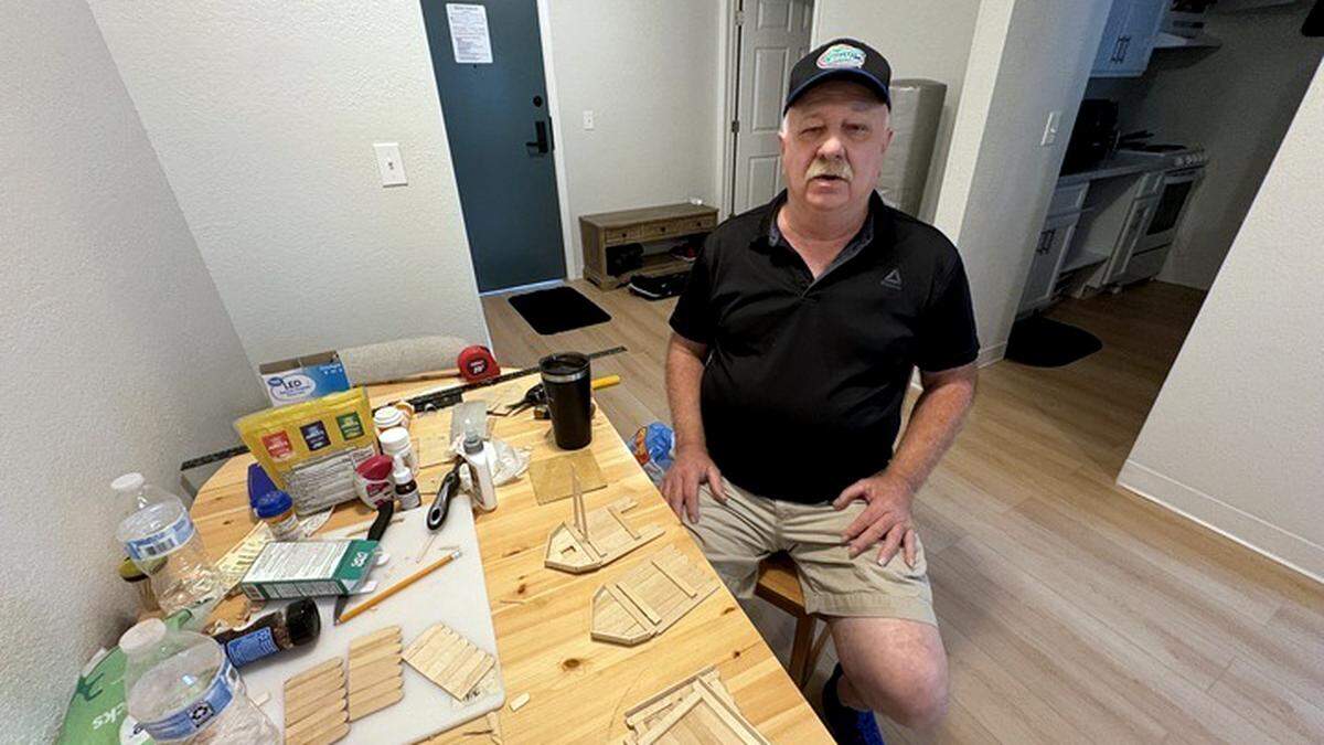 Teddy Pugh sits inside his new studio apartment at The Pines in Morrisville.