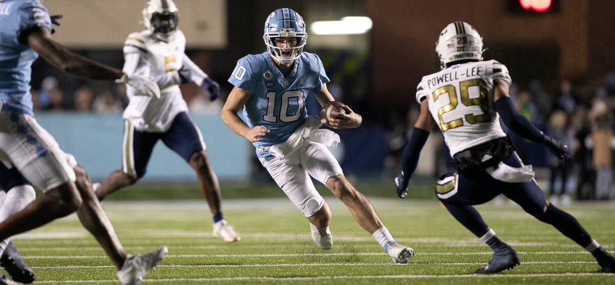 North Carolina quarterback Drake Maye (10) picks up 12 yards in the second quarter against Georgia Tech on Saturday, November 19, 2022 at Kenan Stadium in Chapel Hill, N.C.