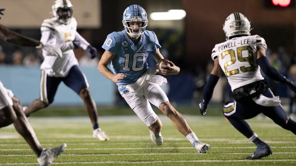 North Carolina quarterback Drake Maye (10) picks up 12 yards in the second quarter against Georgia Tech on Saturday, November 19, 2022 at Kenan Stadium in Chapel Hill, N.C.