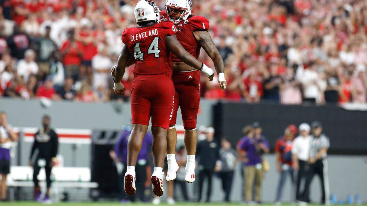 N.C. State’s Davin Vann (1) and Brandon Cleveland (44) celebrate a stop during the second half of N.C. State’s 38-21 victory over Western Carolina at Carter-Finley Stadium in Raleigh, N.C., Thursday, August 29, 2024.