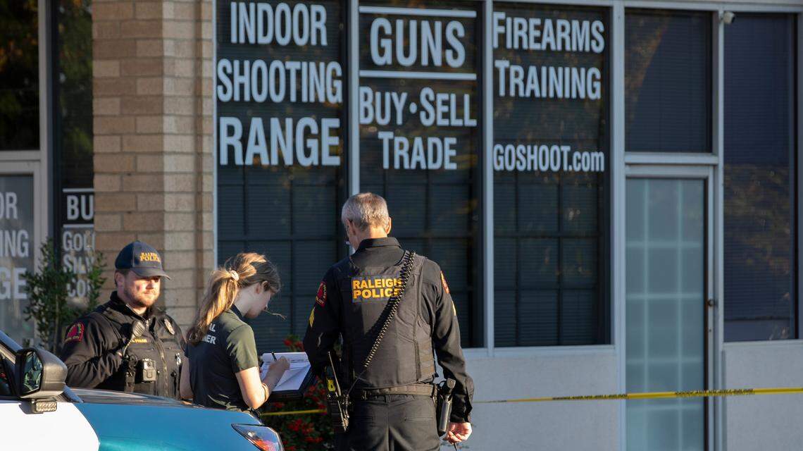 Raleigh police officers confer with an official for the medical examiner’s office outside of the Personal Defense and Handgun Safety Center on Tryon Road in Raleigh. Raleigh police responded to a 3:41pm call of a “reported shooting” a the scene and found an adult male victim suffering from a gunshot wound and are conducting an ongoing investigation.