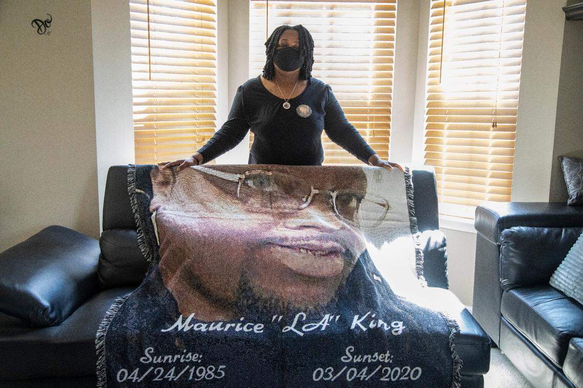 Tiffany King poses with a memorial blanket for her son Maurice King, who died after a fight March 4, 2020, in the Orange County jail. State health department officials found that detention officers violated state regulations by never looking into his cell during inmate checks. Those regulations require jailers to check inmates at least twice an hour.