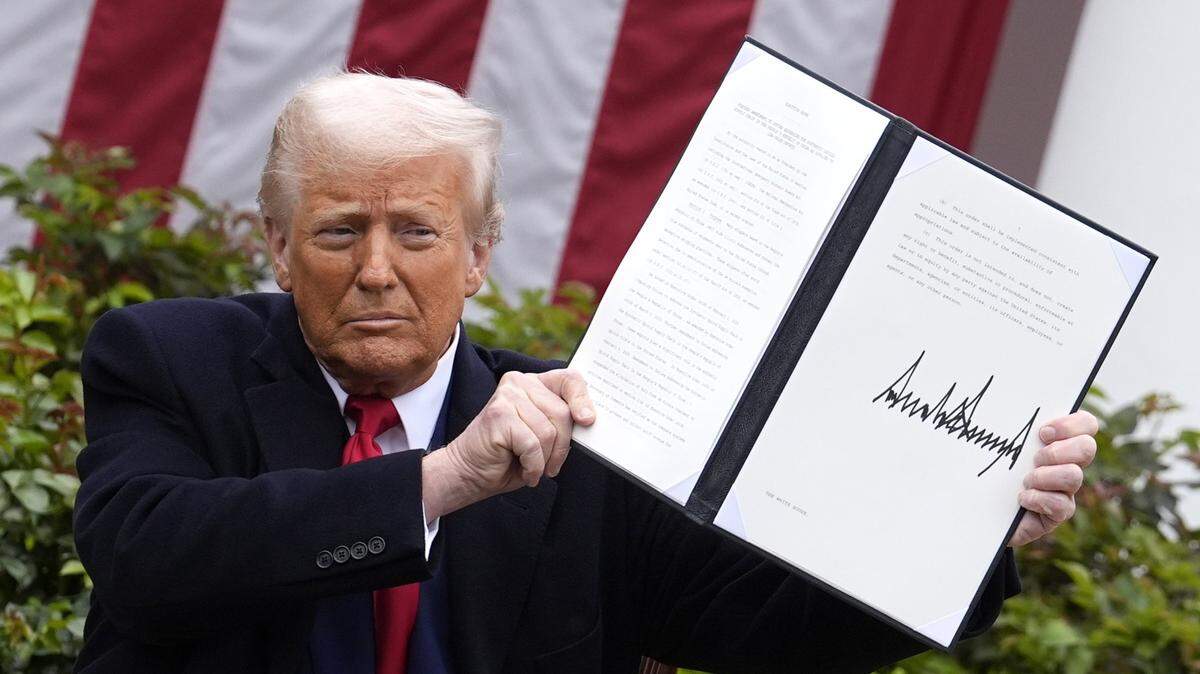 U.S. President Donald Trump signs an executive order on tariffs during an event in the Rose Garden at the White House in Washington, D.C., on Wednesday, April 2, 2025.
