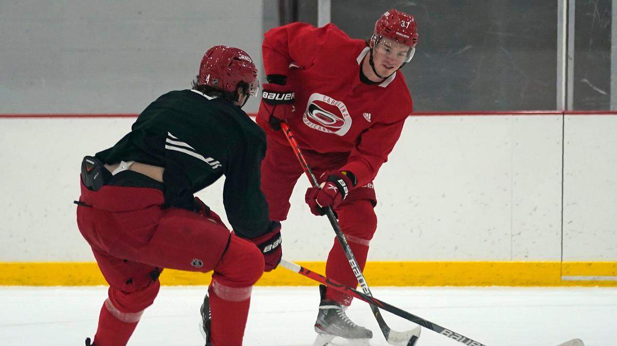 Carolina Hurricanes forward Andrei Svechnikov, skates with the puck while Haydn Fleury defends during NHL hockey training camp in Morrisville on Wednesday, Jan. 6, 2021. (AP Photo/Gerry Broome)