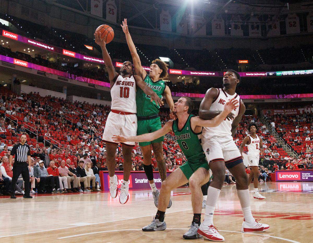 N.C. State’s Marcus Hill, Jr. drives to the basket past USC Upstate’s Isaiah Skinner during the second half of the Wolfpack’s 97-66 win on Monday, Nov. 4, 2024, at the Lenovo Center in Raleigh, N.C.