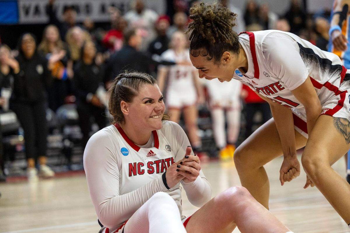 NC State’s River Baldwin (1) and Madison Hayes (21) celebrate after Baldwin was fouled after scoring two late in the second half against Tennessee’s during the second round of the Division I Women’s Basketball Championship at Reynolds Coliseum in Raleigh, North Carolina, on March 25, 2024.